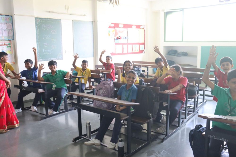 Group photo of students and teacher during an interactive classroom session at Chaitanya School, Best CBSE School in Gandhinagar.