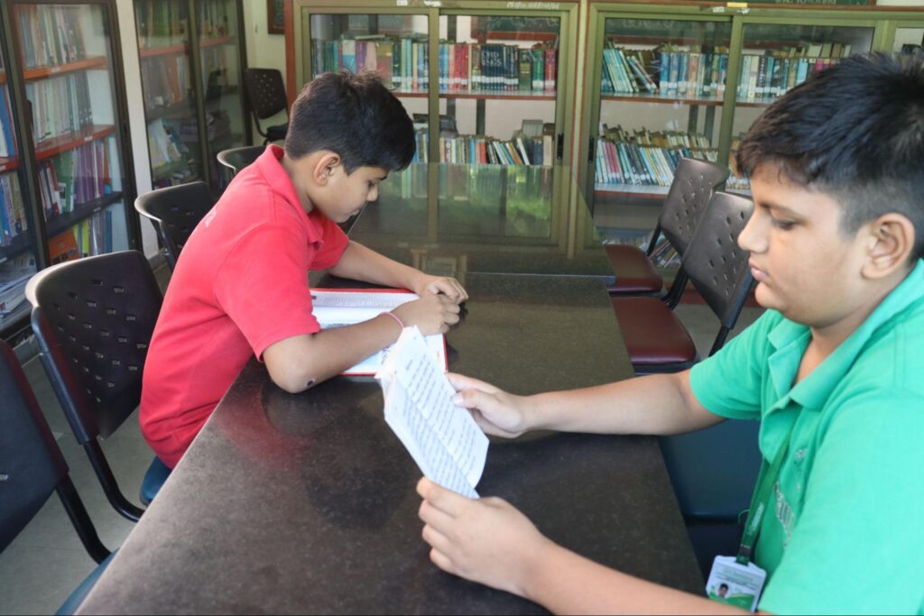 Students reading books together at Chaitanya School library, Best School in Gandhinagar.