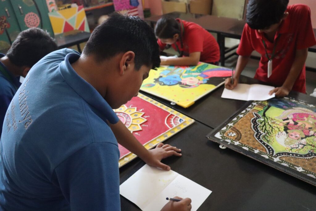 Students creating colorful paintings in a school in Gandhinagar, developing imagination and artistic skills.