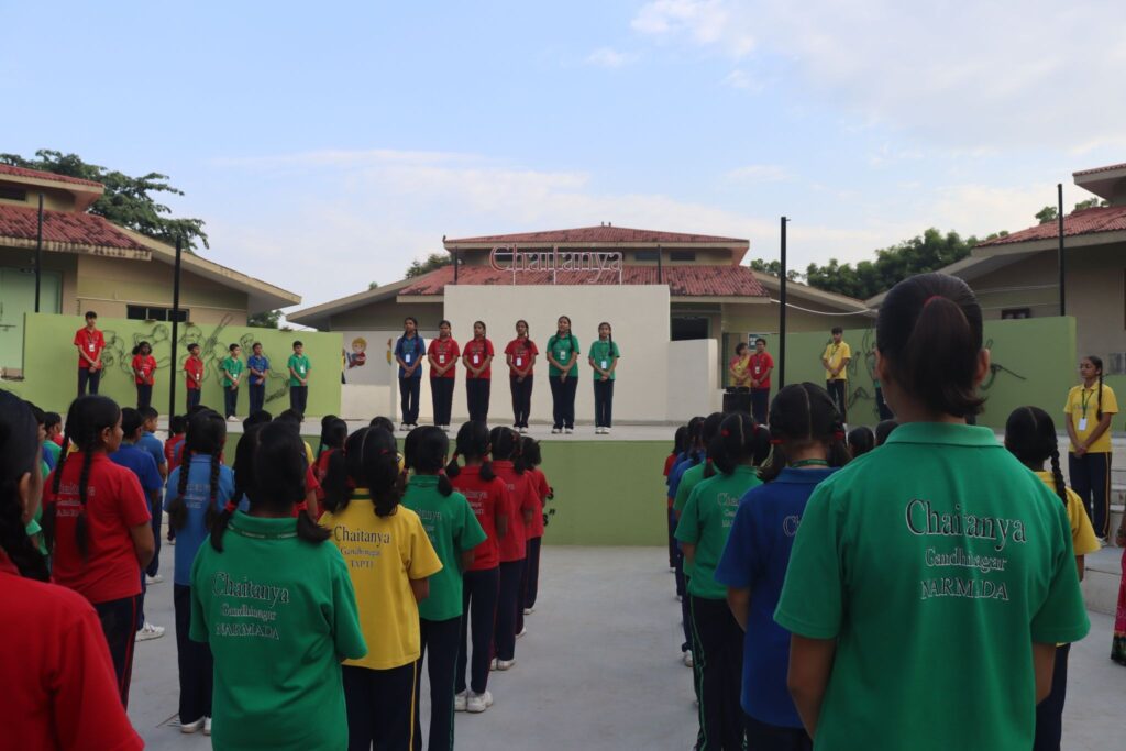Students standing together during the morning assembly, starting the day with focus and positivity - Chaitanya School