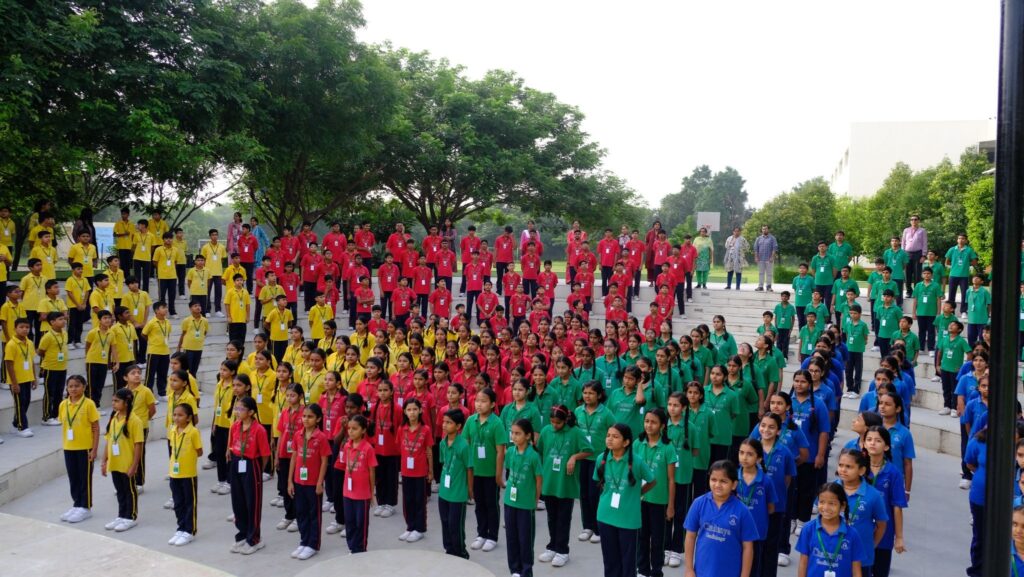 Students lined up in their house uniforms during assembly, showing team spirit and pride - Chaitanya School.